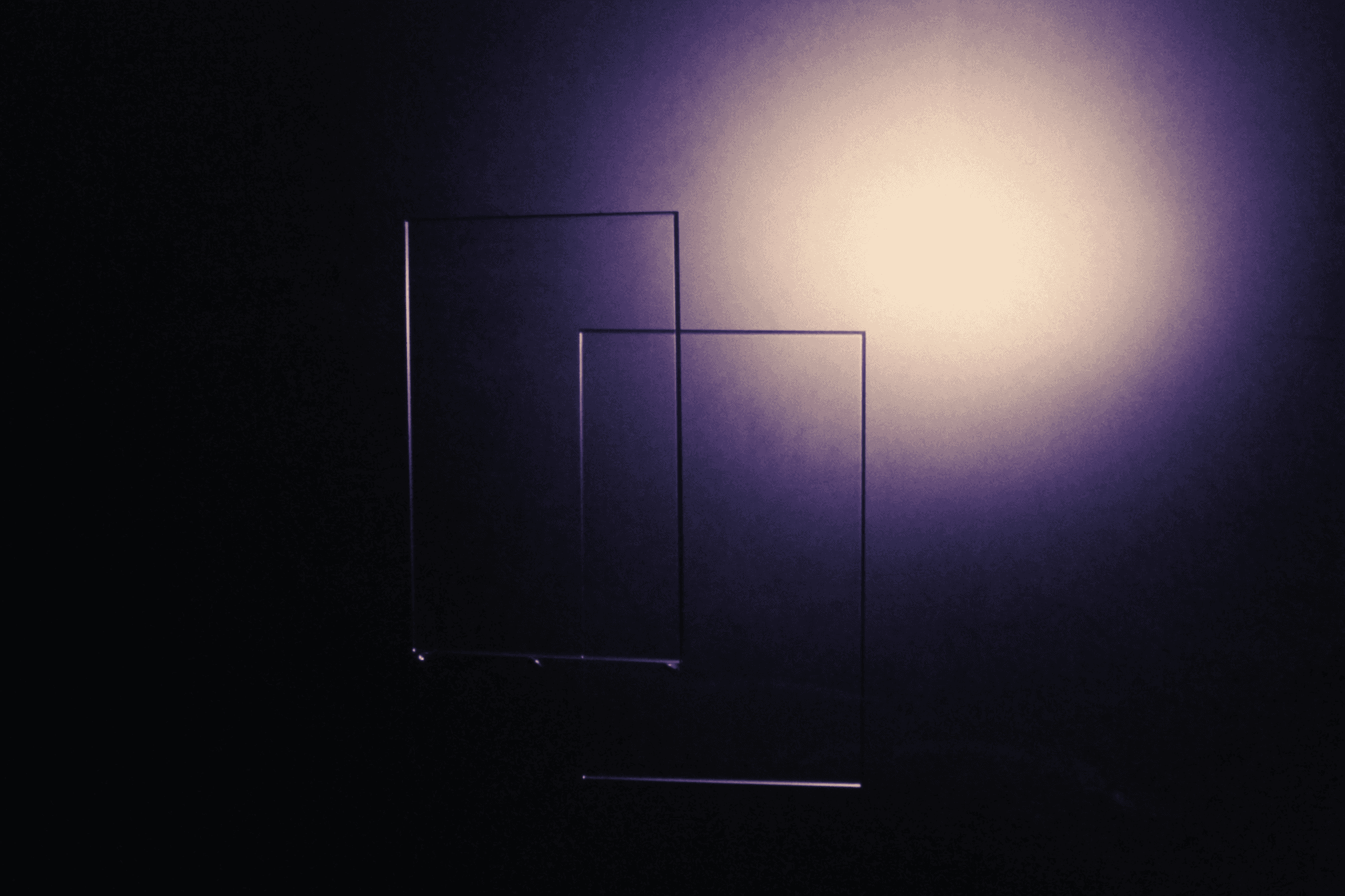Translucent glass panels lit against a dark backdrop.